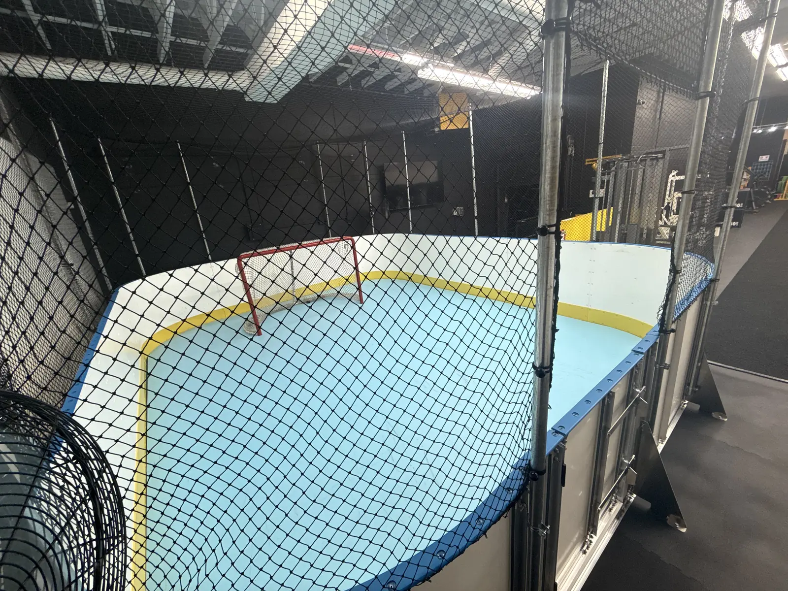 The synthetic ice surface and net at The Hockey Lab